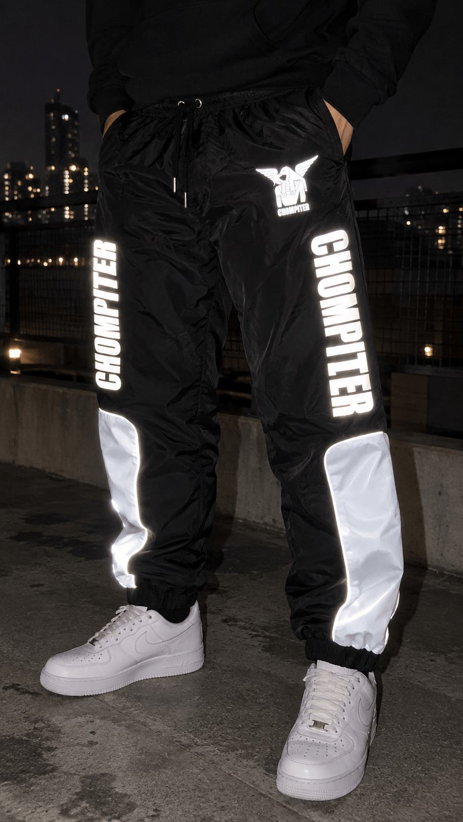 Joggers reflectivos CHOMPITER brillando de noche en NYC, vista frontal